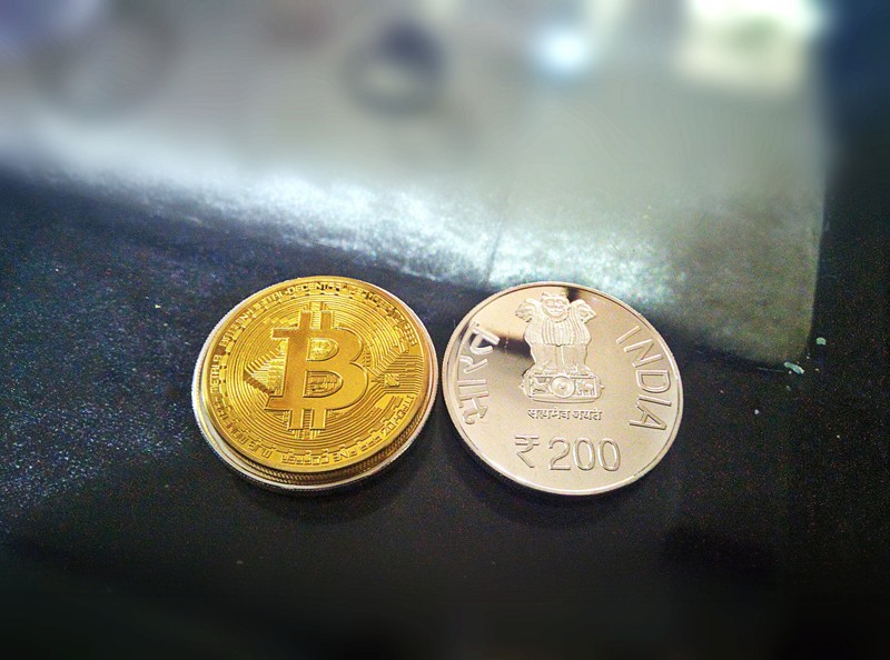 2 coins on a table - bitcoin and Indian Rupee