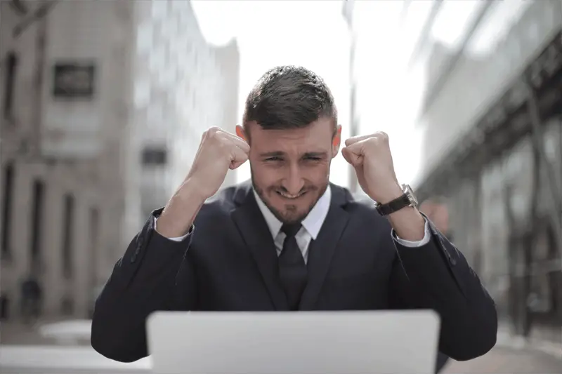 man in suit celebrating an accomplishment - business success