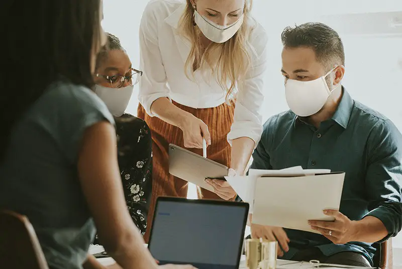 Business people with face masks having a meeting