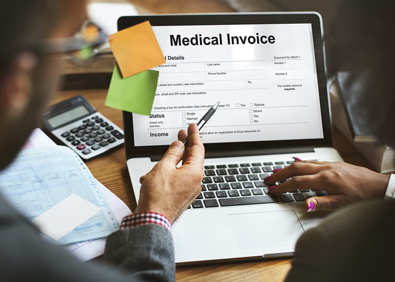 Patient Medical Invoice - medical billing document on laptop screen