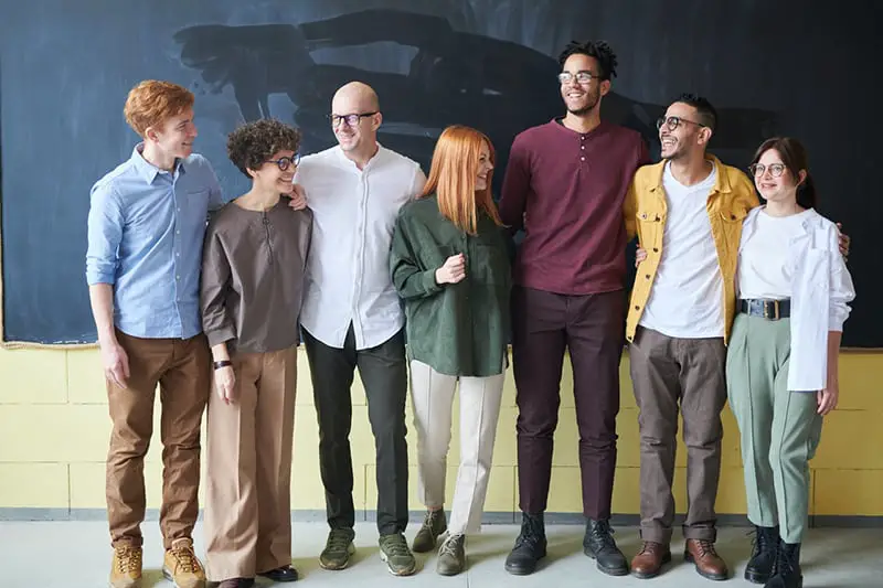 group of staff members standing in front of a chalk board