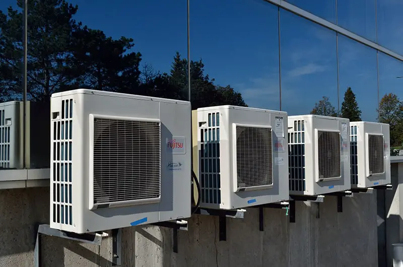 Air conditioner near the building glass window