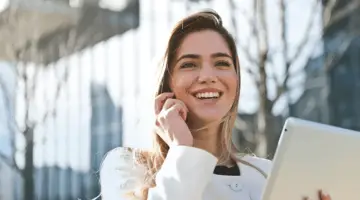 A smiling woman while talking on her mobile phone