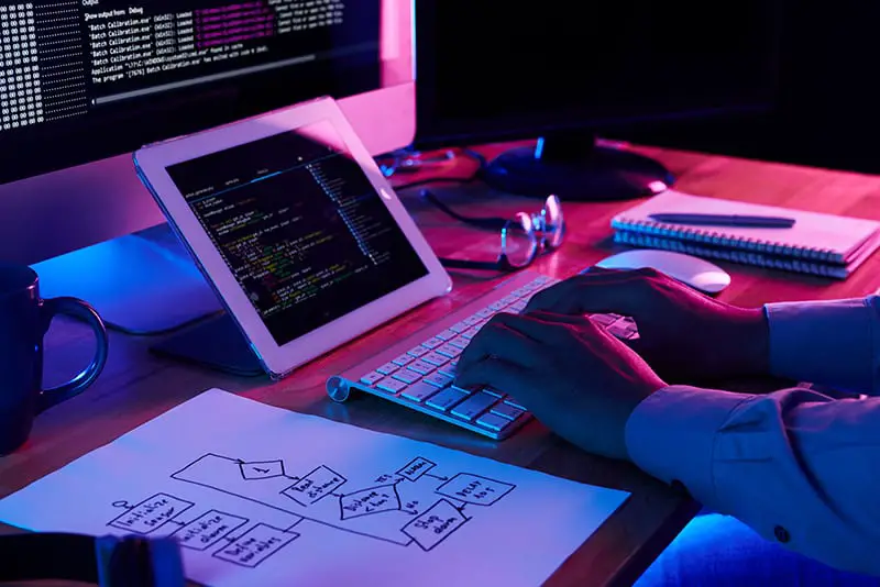 A programmer working on his office desk