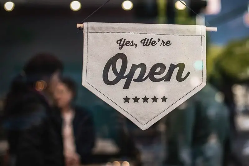 A shallow focus photo of white open signage