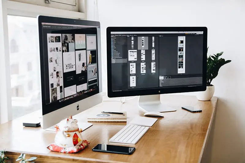 Silver and black Imac in wooden desk