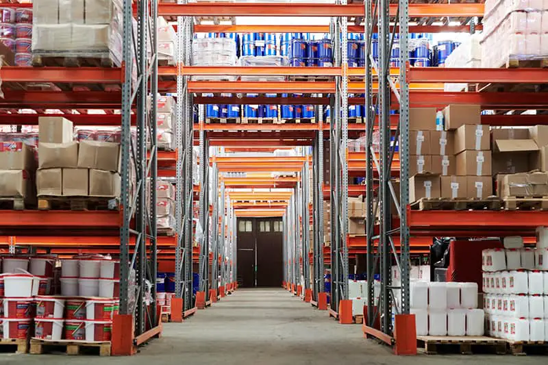 Inside the warehouse with white containers and boxes on rack