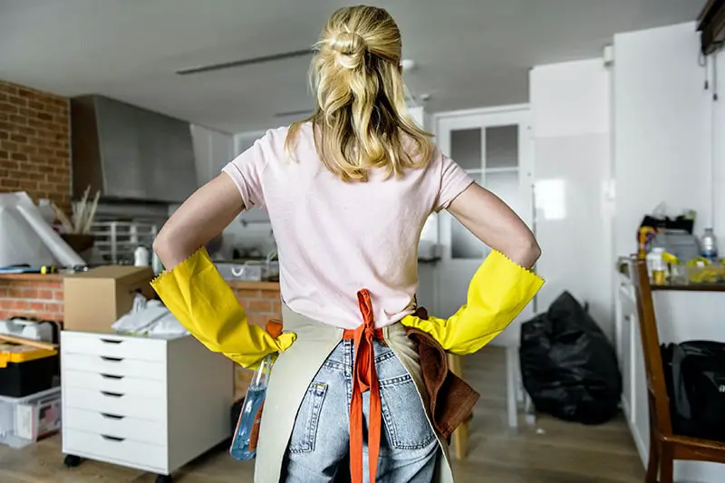 Woman wearing yellow gloves and apron