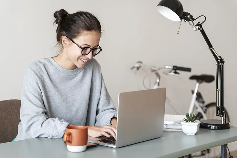 A happy woman using computer laptop