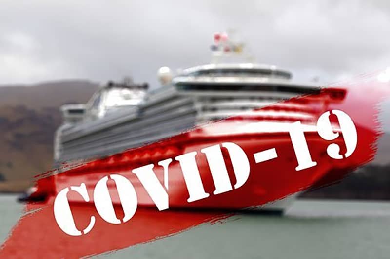 cruise ship out to sea - red covid-19 banner across image