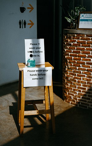 wooden table with hand sanitizer bottle on top