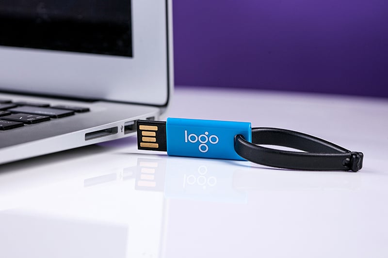 Promotional product - USB stick next to laptop computer