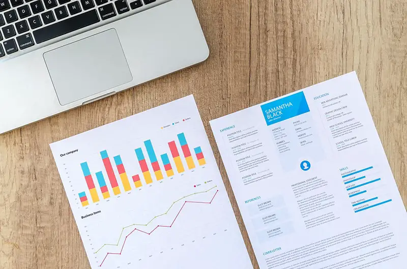 cash flow charts and graph next to document and laptop