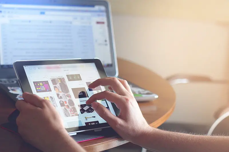 Hand of a person browsing in the tablet screen