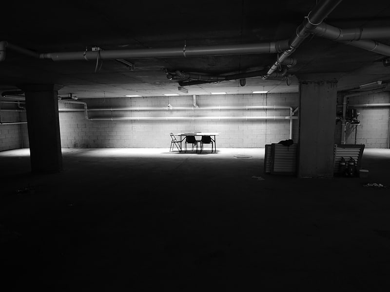 chairs and tables in the basement of an unused residential space