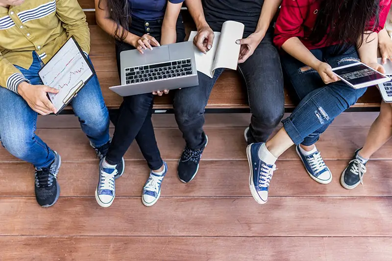 A group of college students holding gadgets