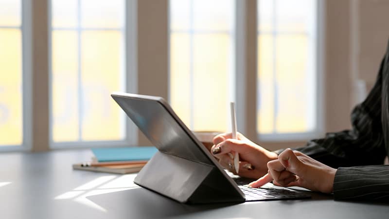 person using tablet computer with keyboard