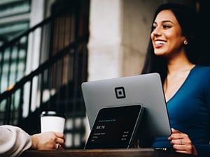 Woman smiling while in front of her computer