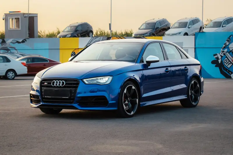 Audi S3 (8V) in blue in the parking lot of used cars.