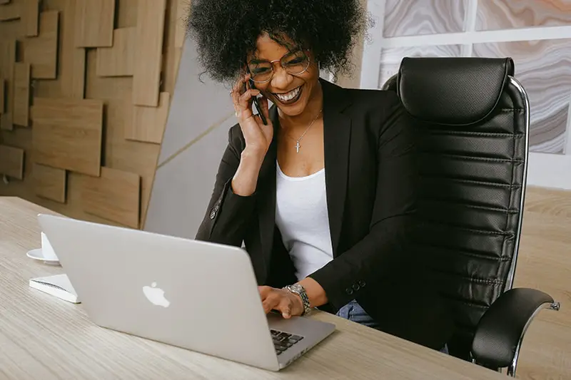 Woman in black blazer sitting on black office chair