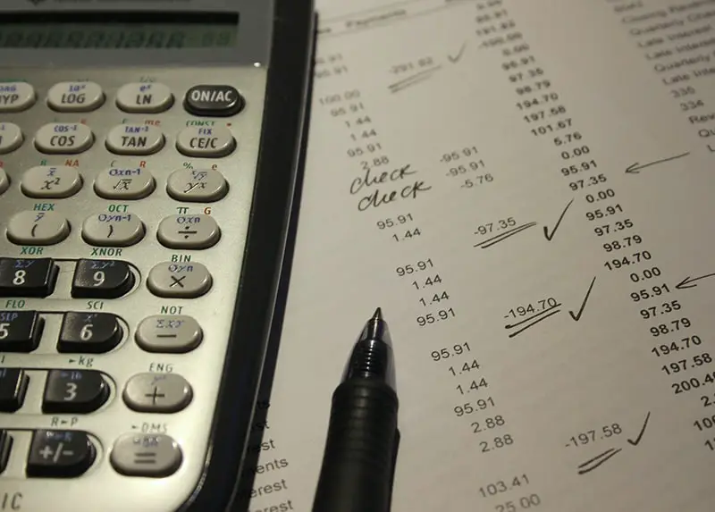 calculator next to accounting documents and pen