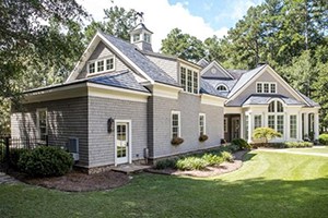 Gray and white concrete house with attic