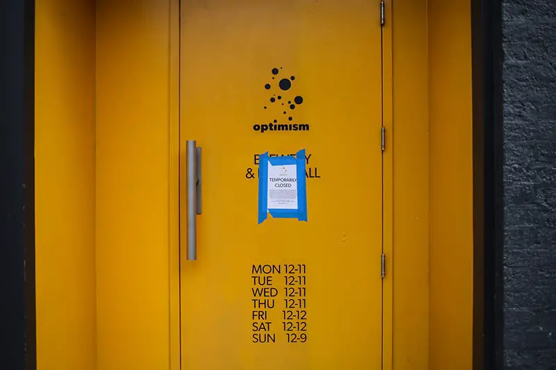 Yellow metal door with blue and white sticker