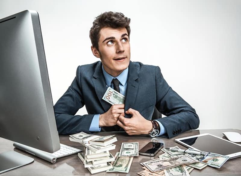 A man putting paper bills inside his coat