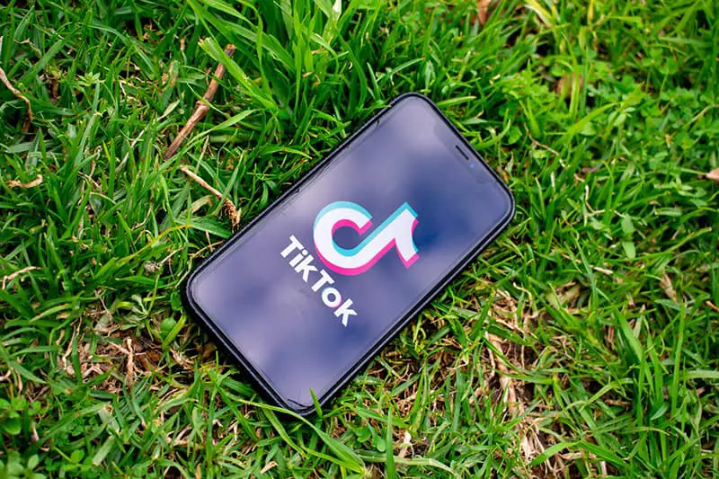 Tiktok logo on black smartphone screen