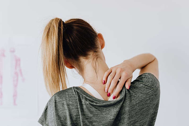 Woman showing pain spot on her back