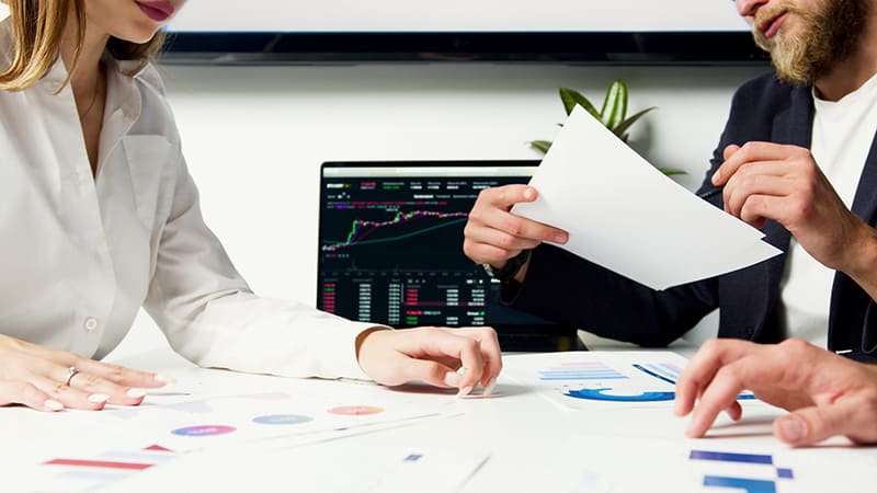 Person in white long sleeve shirt holding white paper