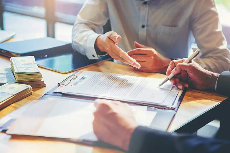 Businessman signing a document