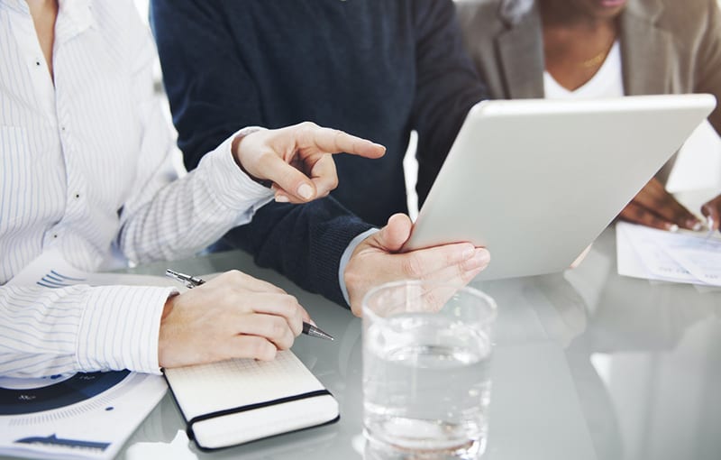 business people and IT consultant using a digital tablet