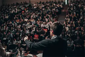 A man speaking in front of the crowd