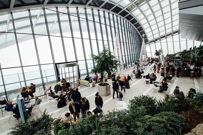 People sitting at tables in an Industry Exhibition hall 