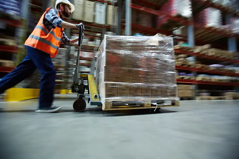 A man using pallet racks and lifter