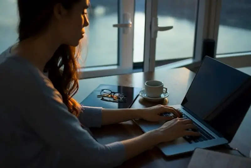 Woman working at a desk on laptop