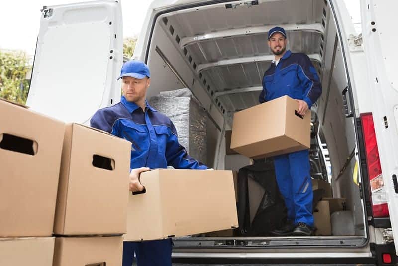 two men removing boxes from a commercial van following office move