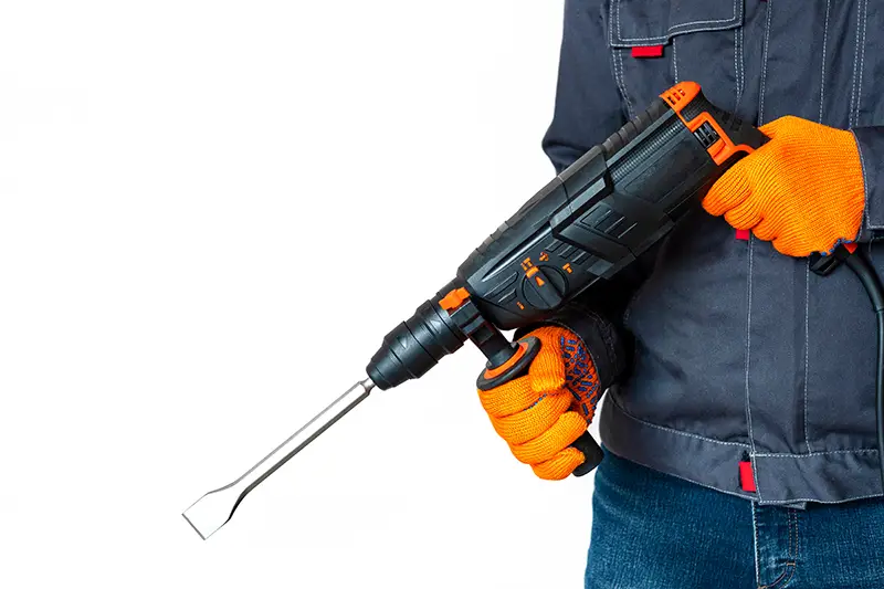 Workman holding rotary hammer