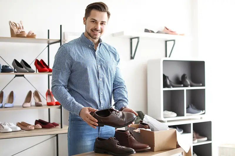 Young man choosing shoes in a store