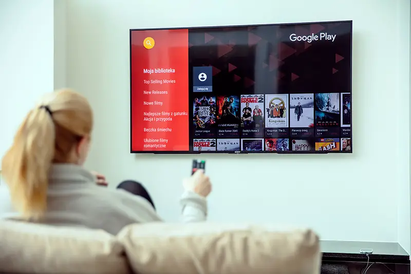 Woman in the couch while watching tv