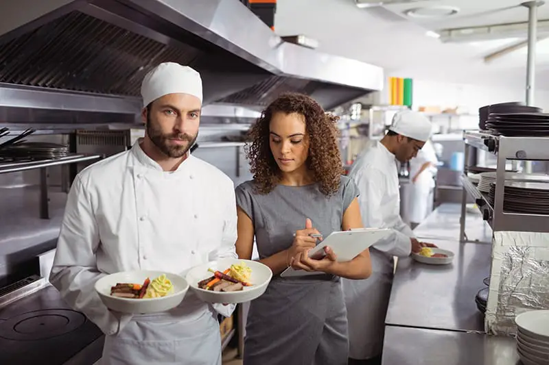 Portrait chef presenting his food in plates