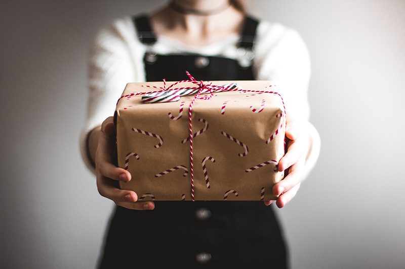Person holding a gift wrapped box
