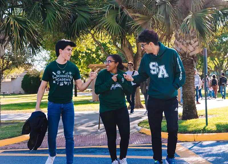 Three young people wearing science academy uniforms