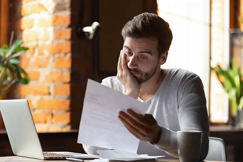 Frustrated man reading letter
