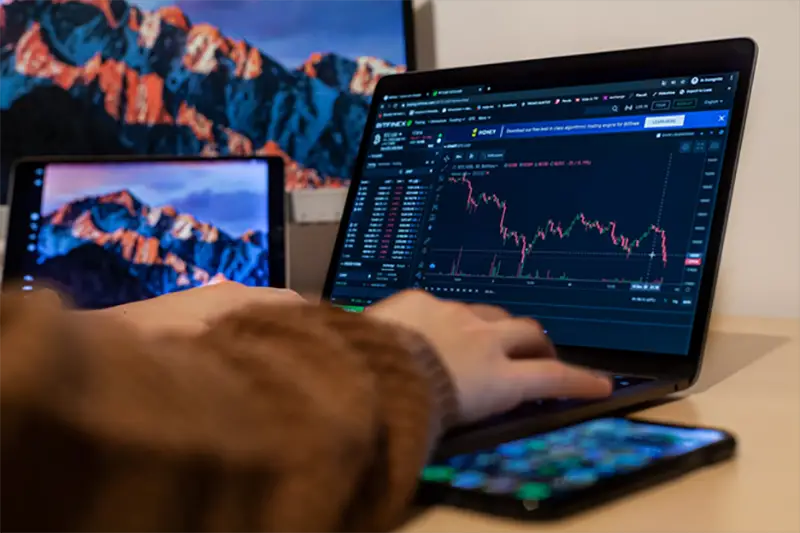 Forext trader working on a laptop