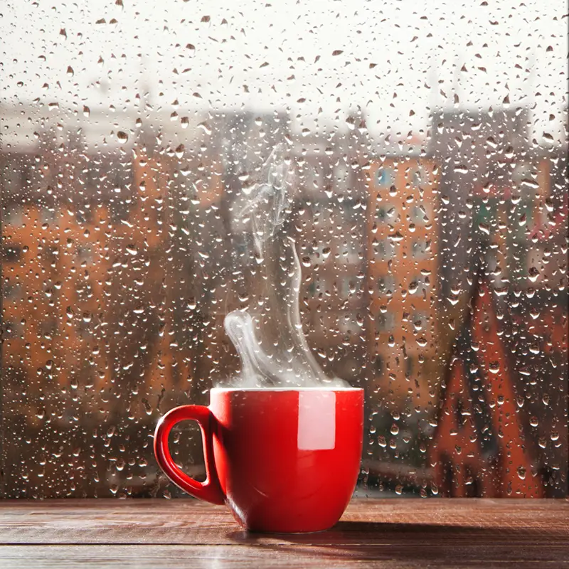 steaming hot beverage in red mug on table