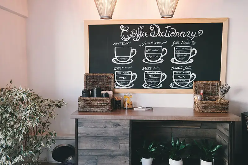 Brown wooden table near menu board