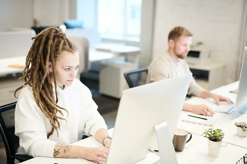 Man and woman working in front of the computer