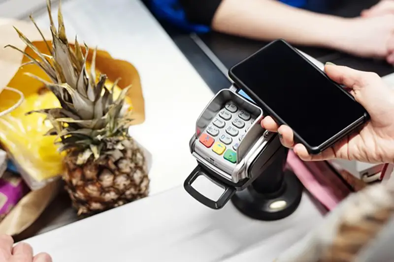 Person paying goods using smartphone